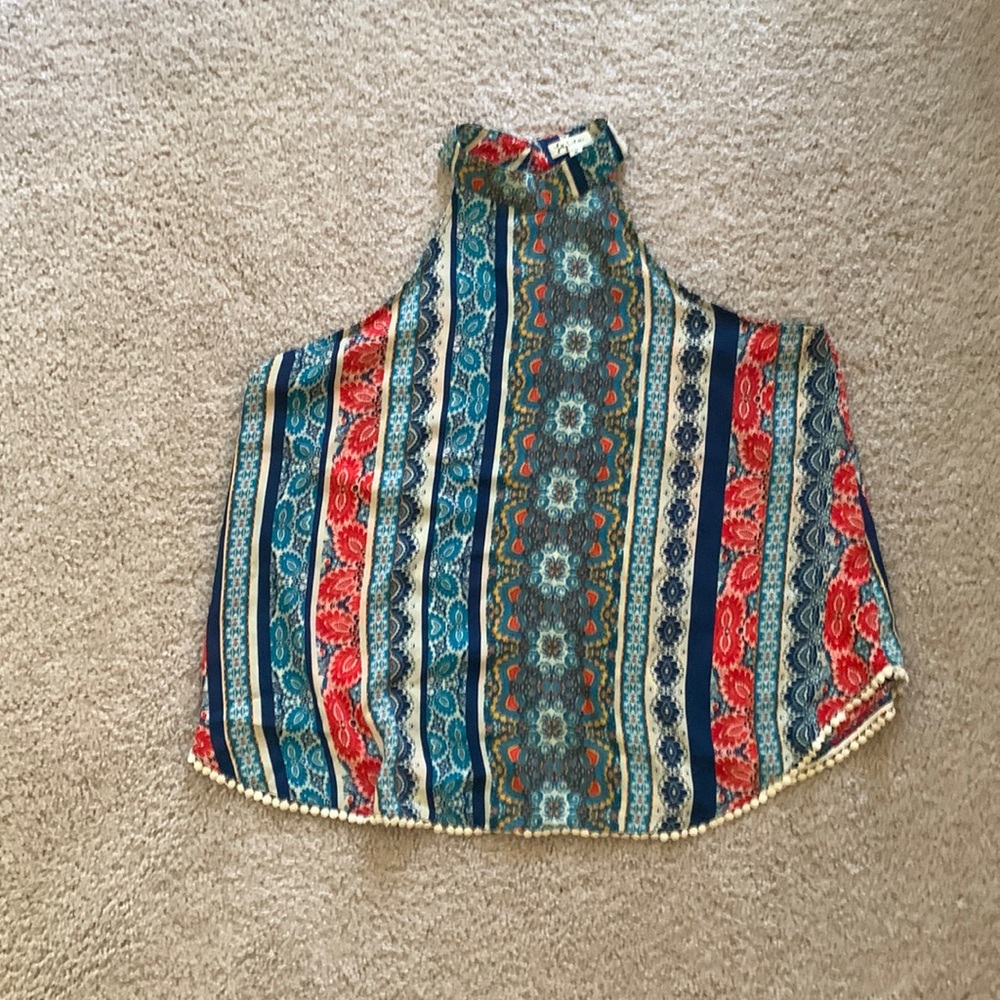 Colorful high neck , sleeveless top. Beautiful pompon like bottom trim.
